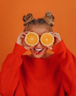 Girl In Orange Sweater Holding Lemon painting by numbers